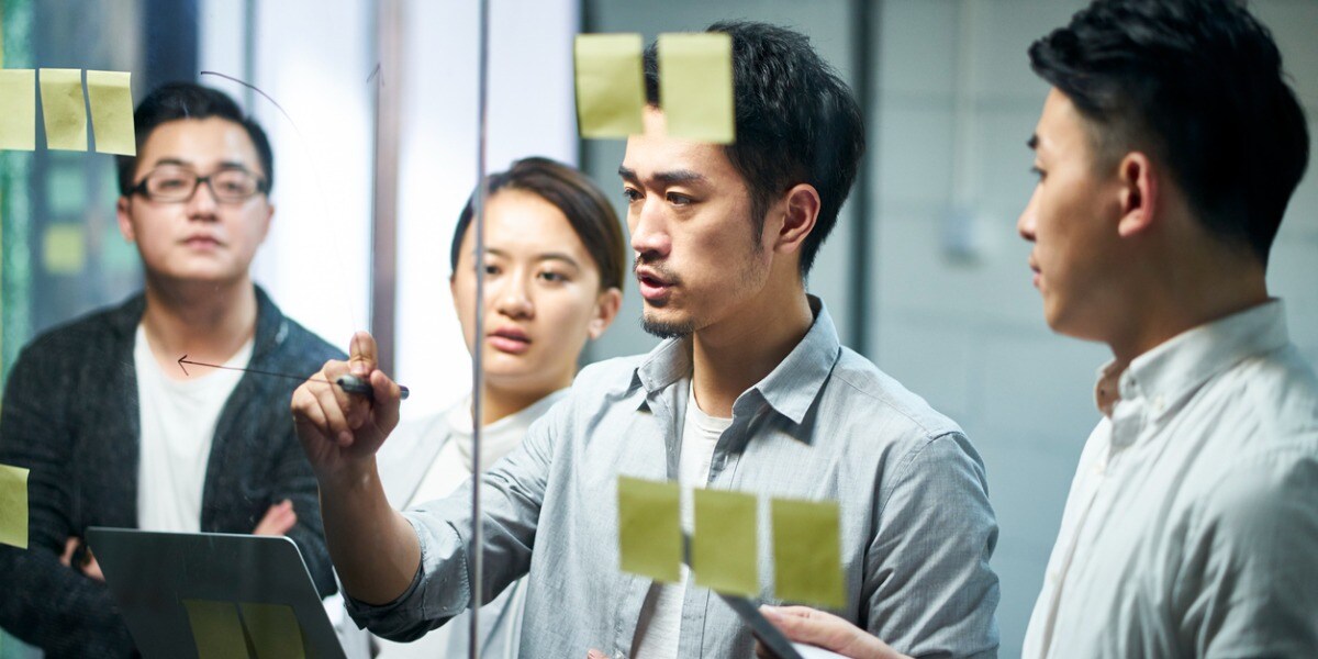 group of people brainstorming with sticky notes