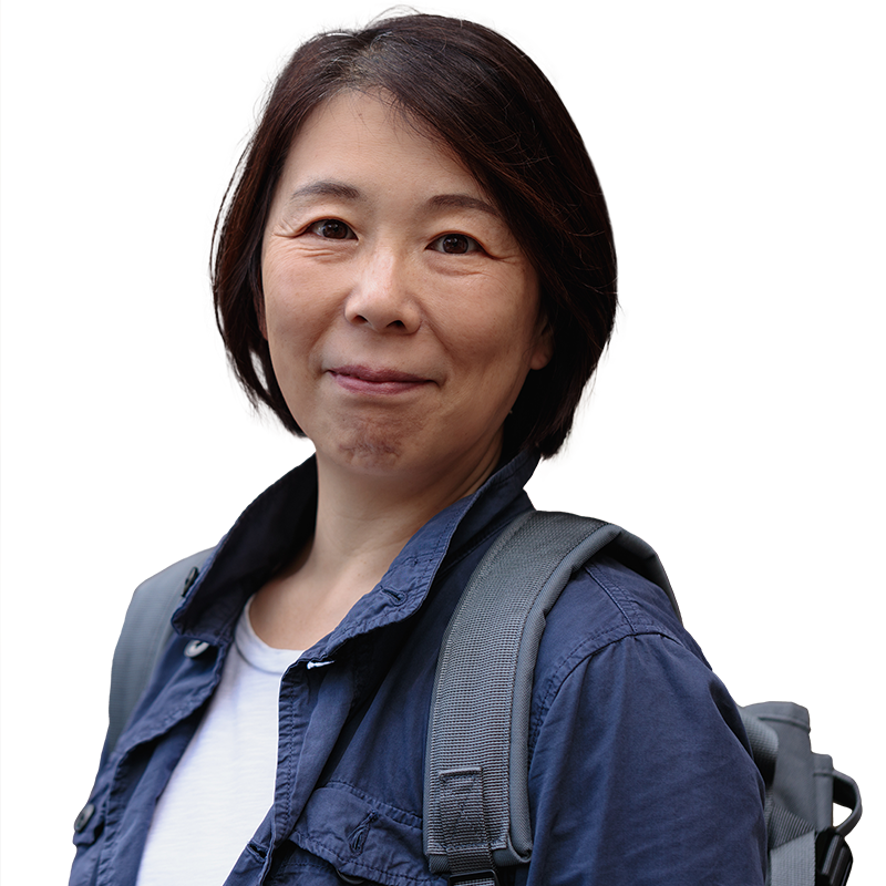 woman with backpack smiling at camera