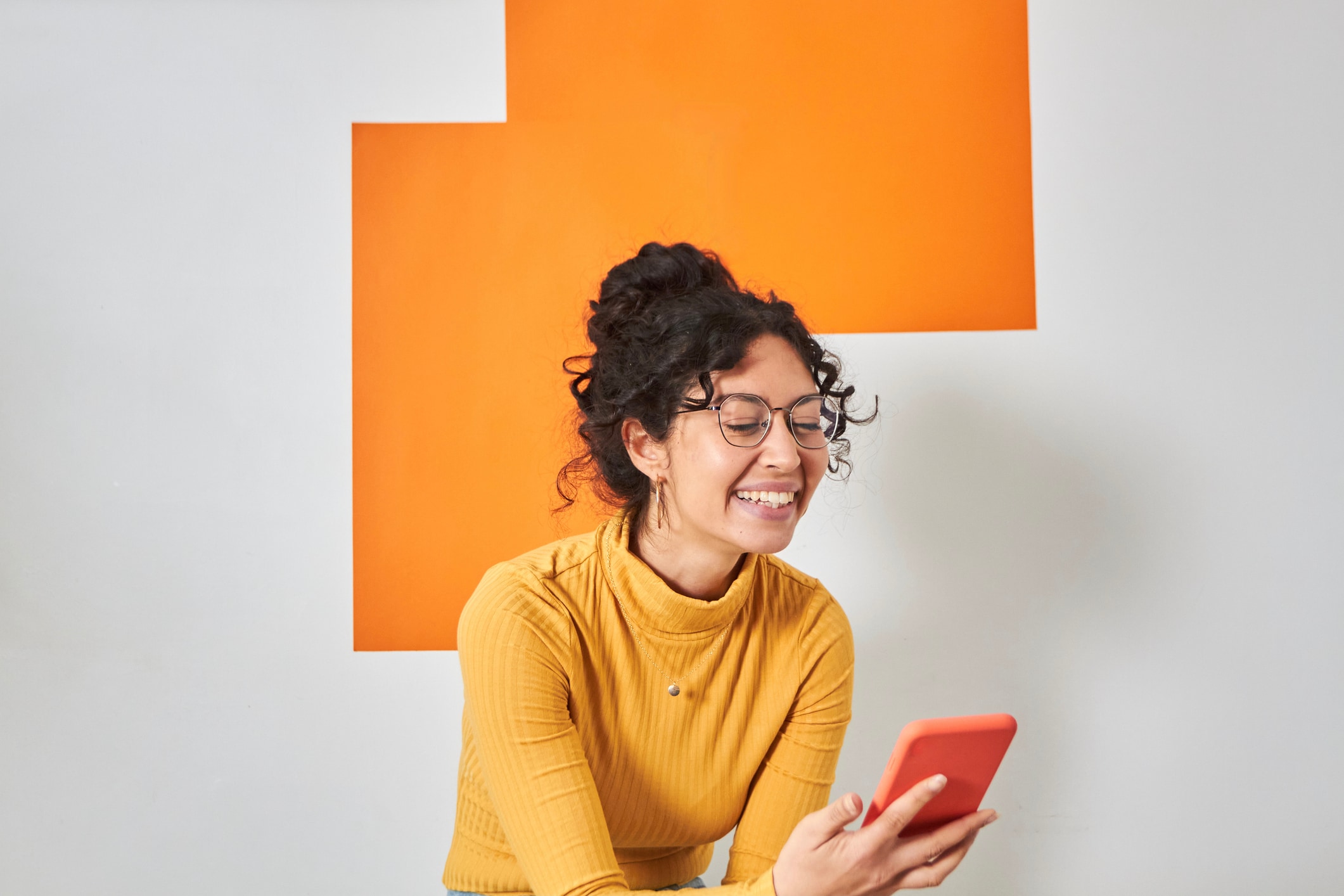 woman smiling at phone