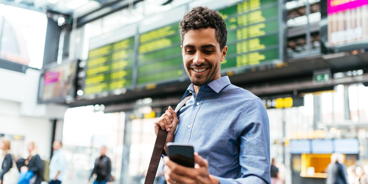 man at the airport using cellphone