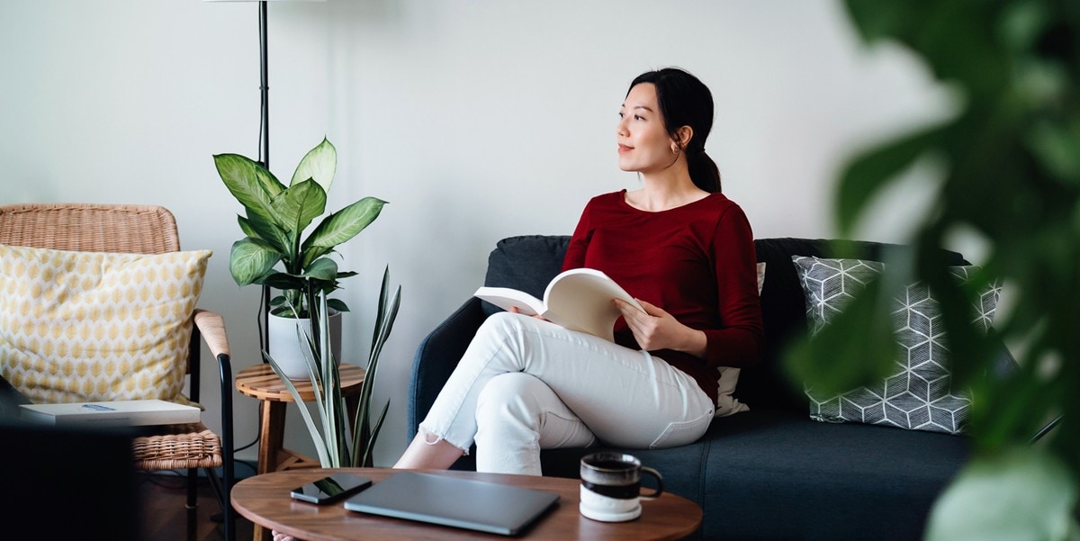 woman sitting in a lounge holding a book