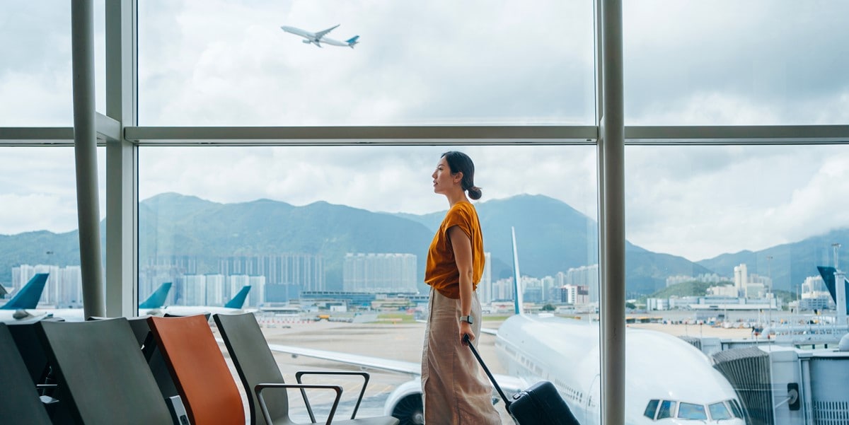traveler walking through airport with luggage