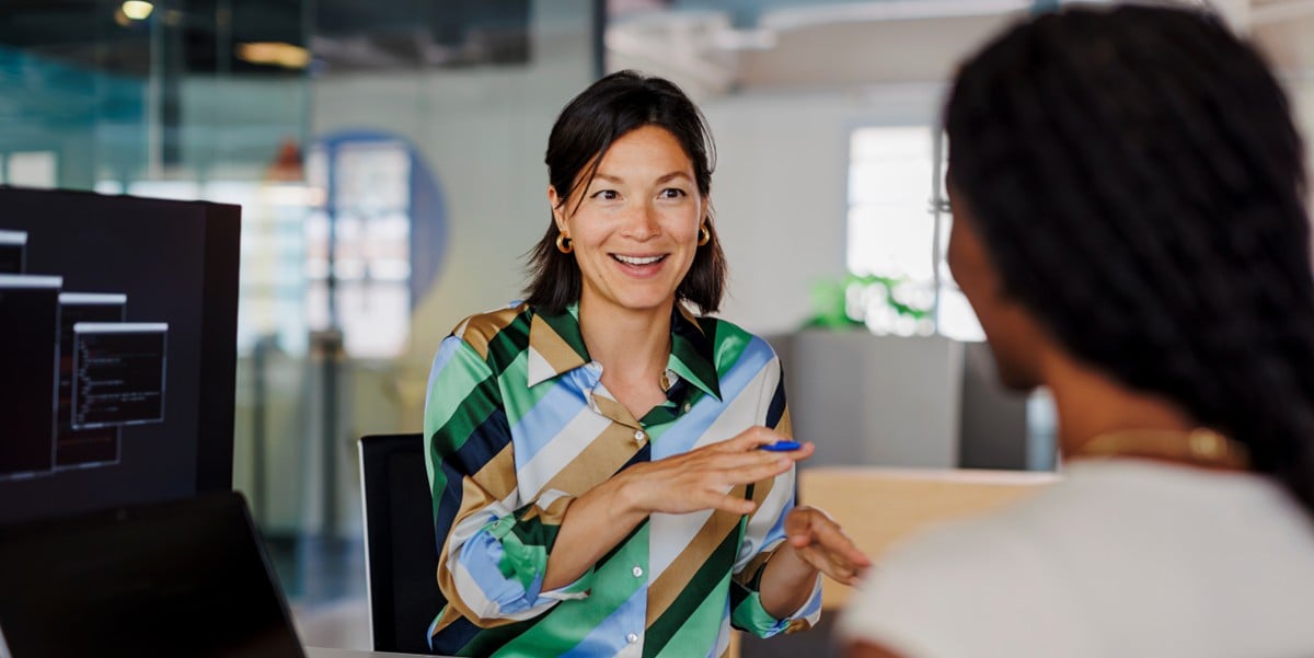 professional woman in meeting with another colleague at the office