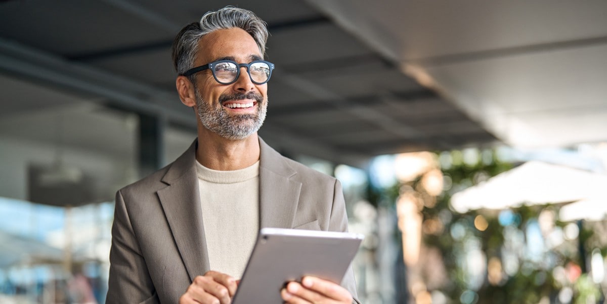 professional man in office holding a tablet