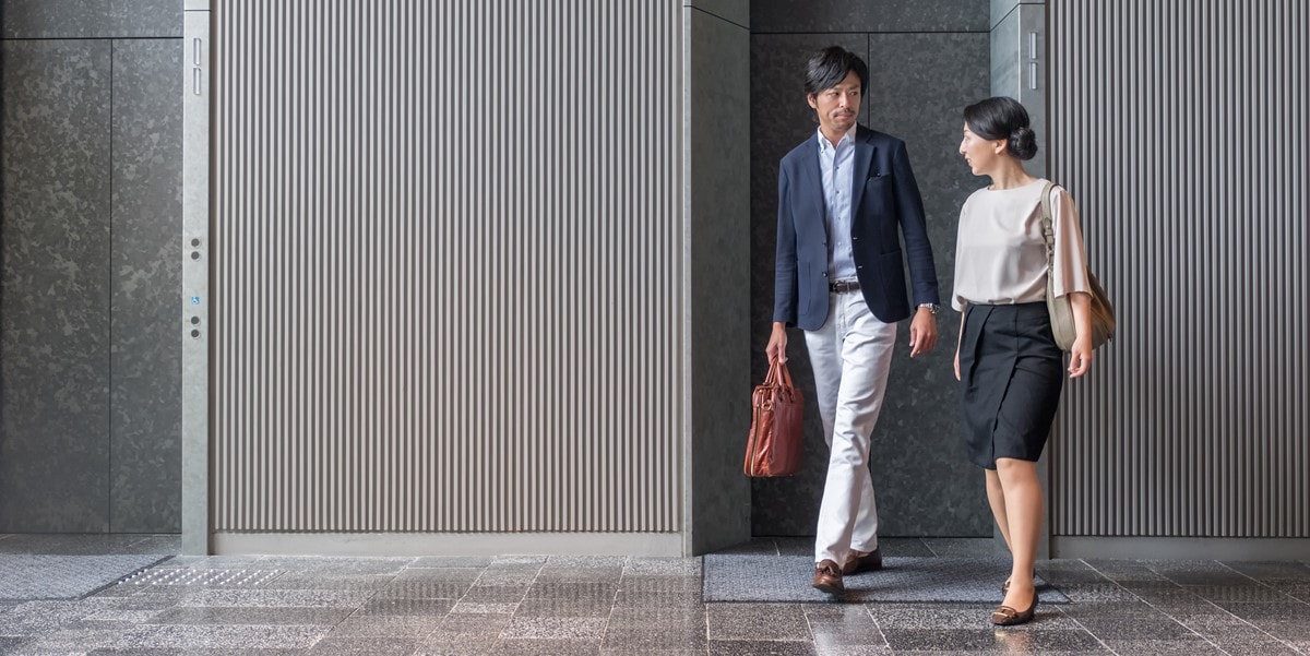 two professionals walking in building
