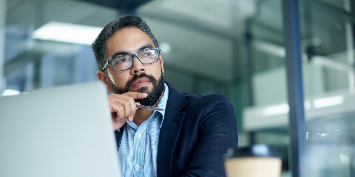 professional man at desk using laptop