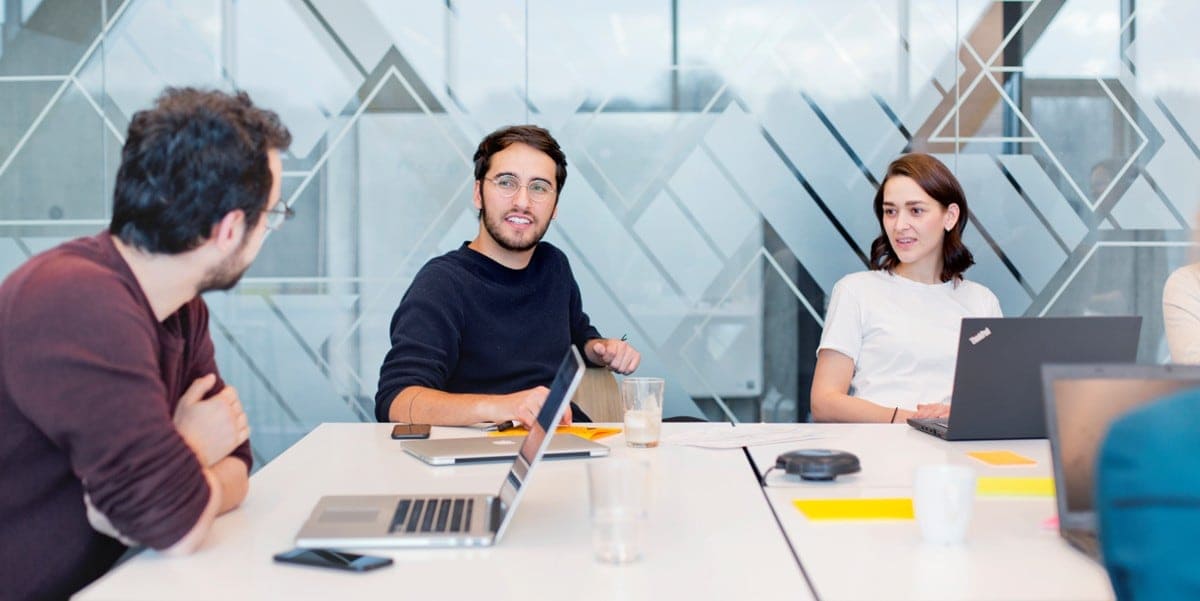 three professionals sitting at a table in the office