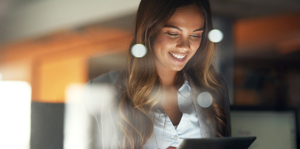 happy lady looking at tablet
