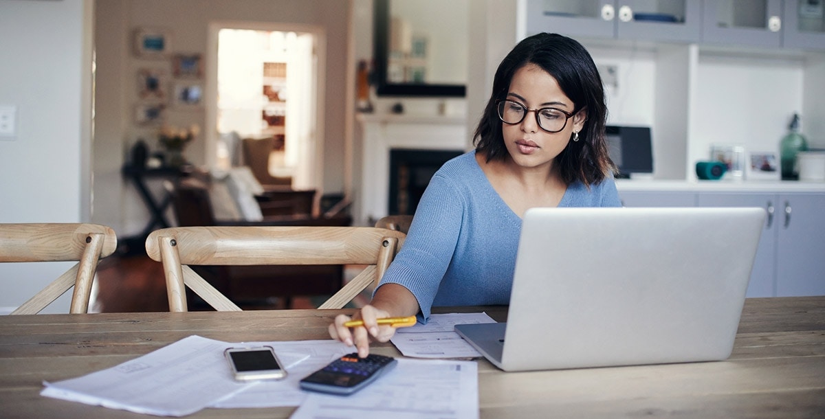 woman with laptop and calculator