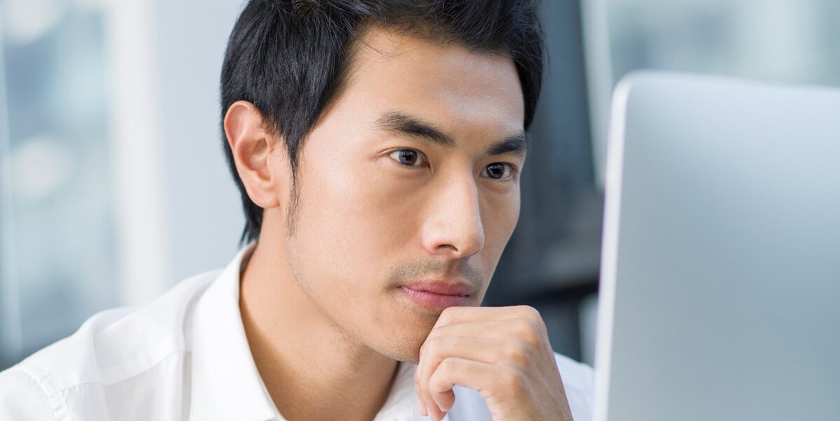 professional man working, looking at computer screen