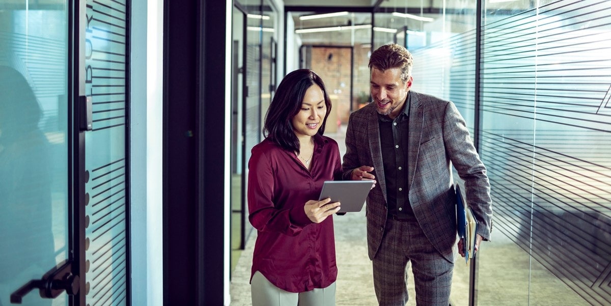 Two people in office reviewing document