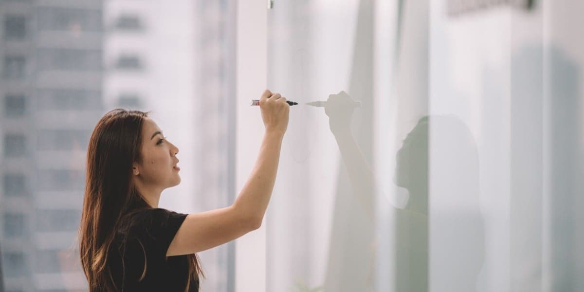 business woman writing on a whiteboard