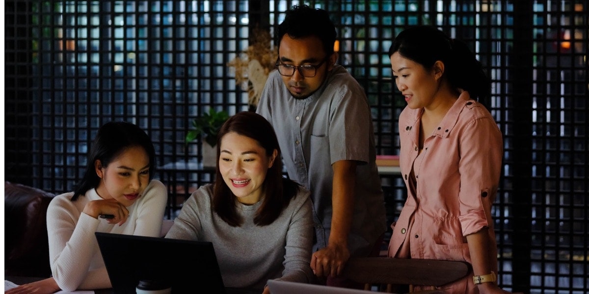 coworkers collaborating around a computer