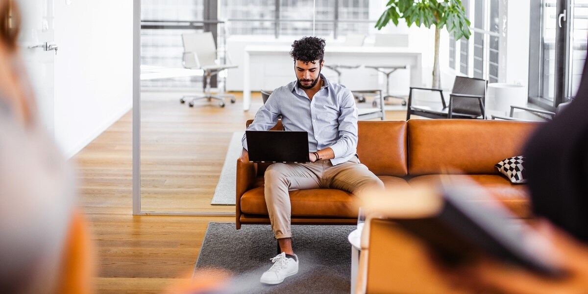 man working at an office, couch