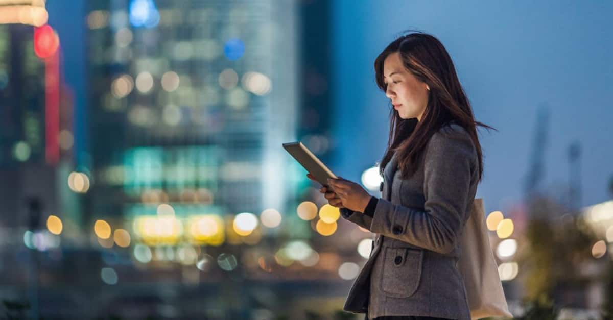 woman looking at tablet