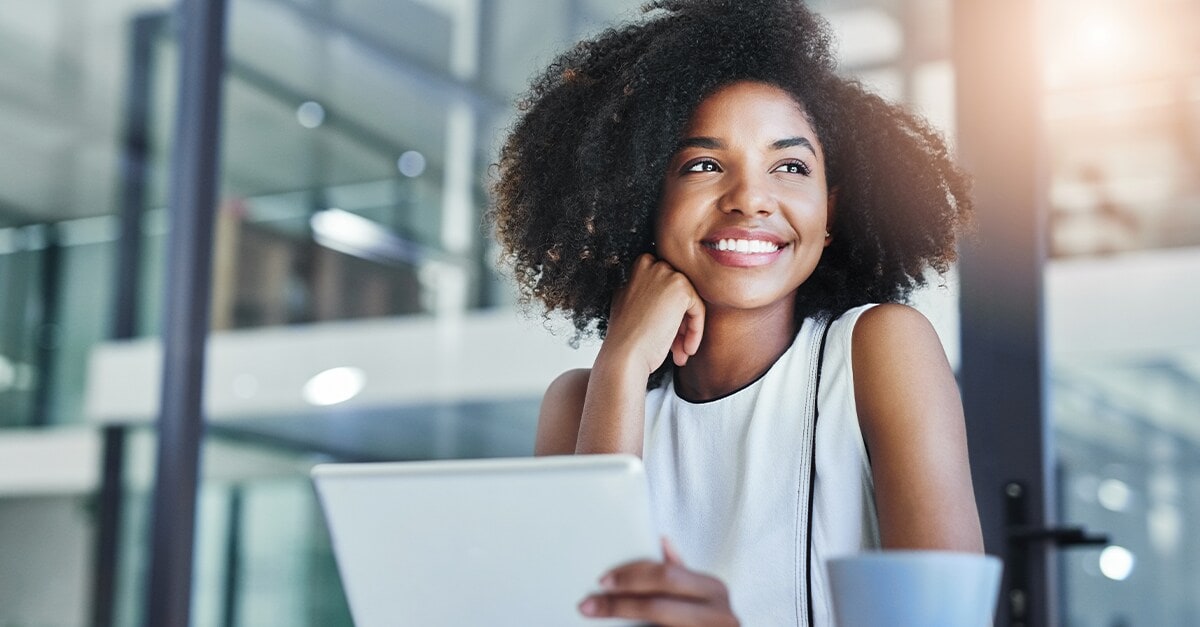 woman sitting and smiling looking off into the distance