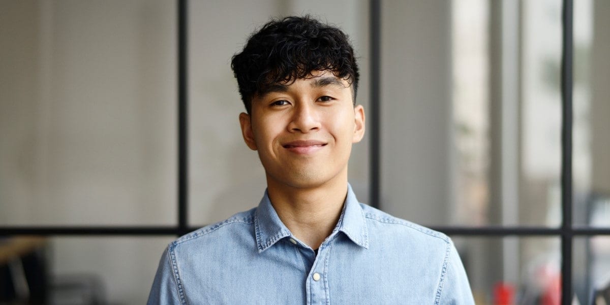 man in blue shirt smiling at camera