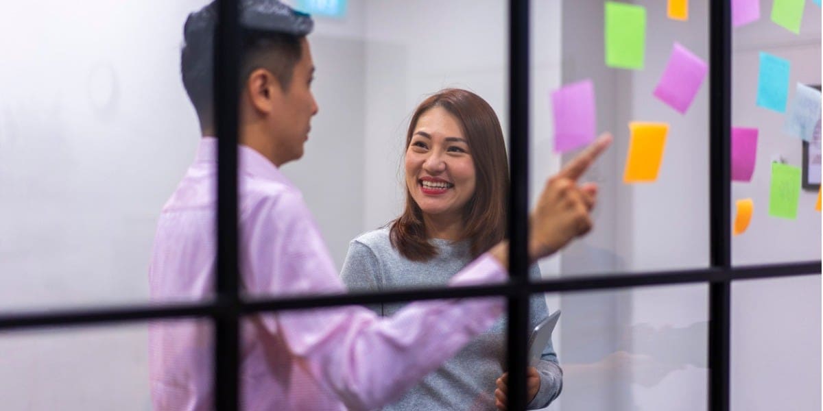 coworkers having a discussion in meeting room