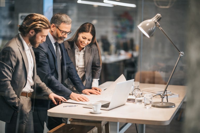 coworkers collaborating at a desk