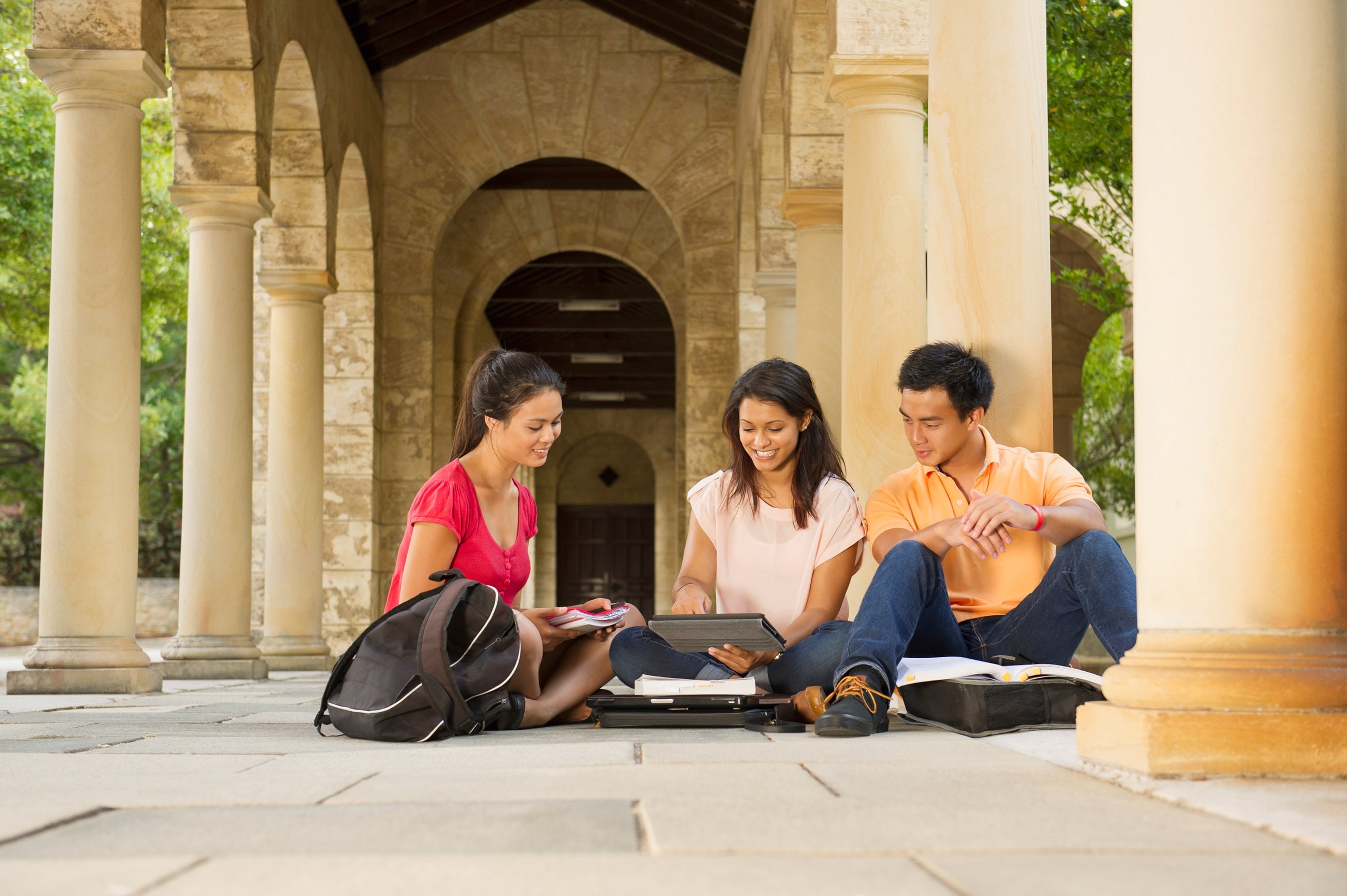 three people sitting on the ground