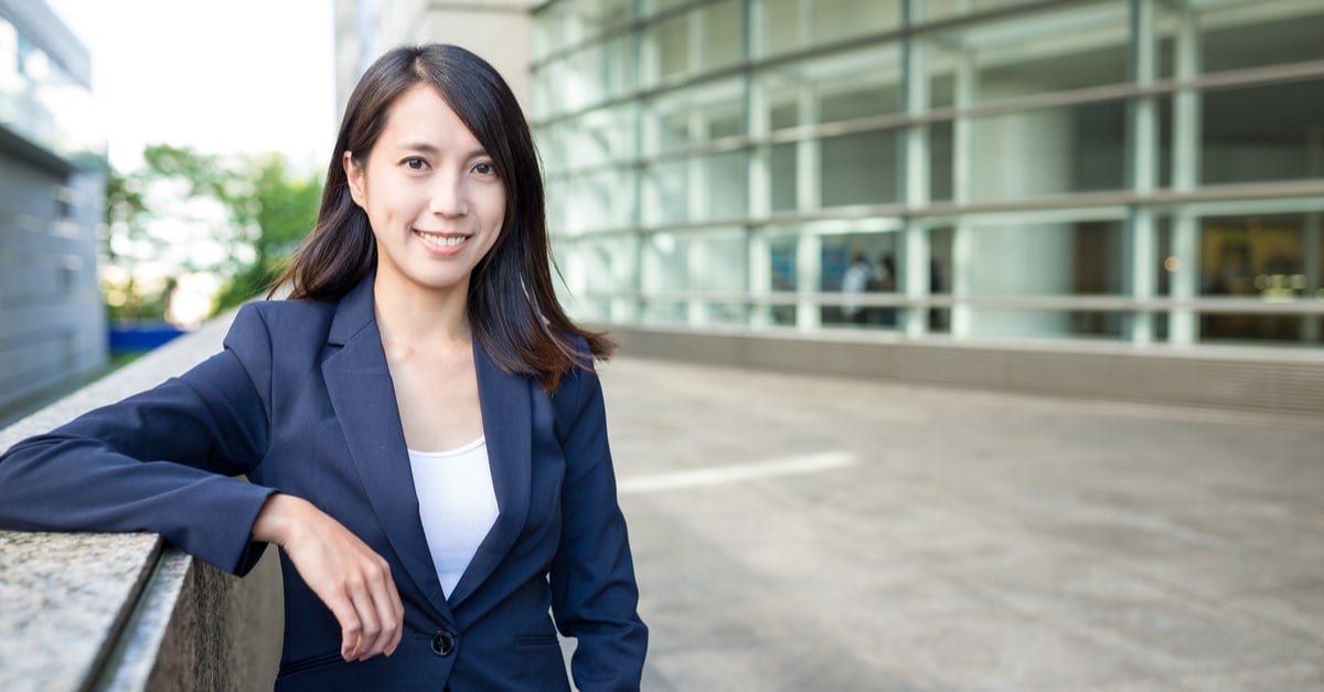 business woman smiling outside an office