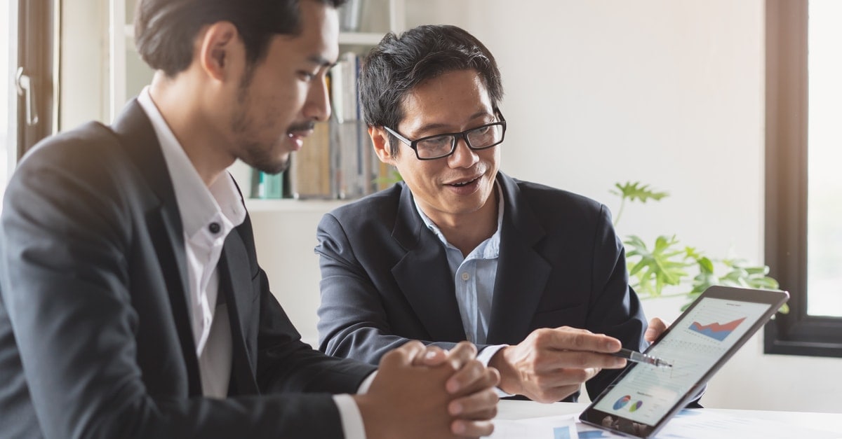 business men looking at a tablet