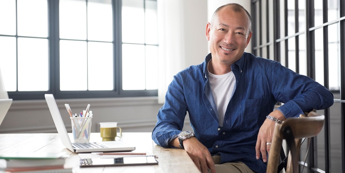smiling man at a desk