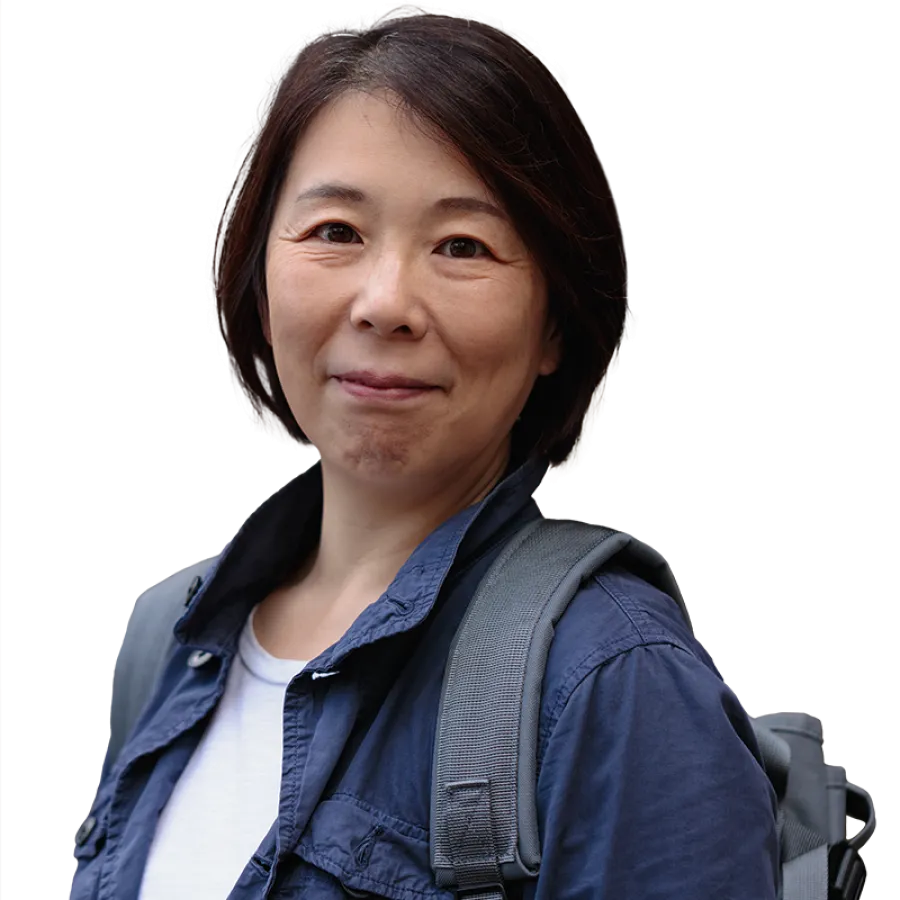 woman with backpack smiling at camera