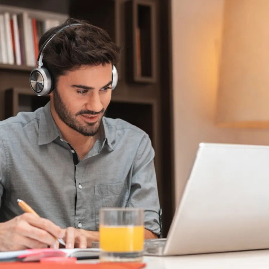 professional man seated at desk with laptop