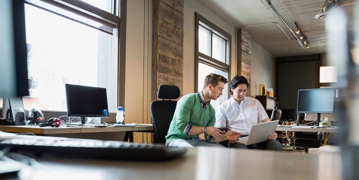 two business people working together on a laptop