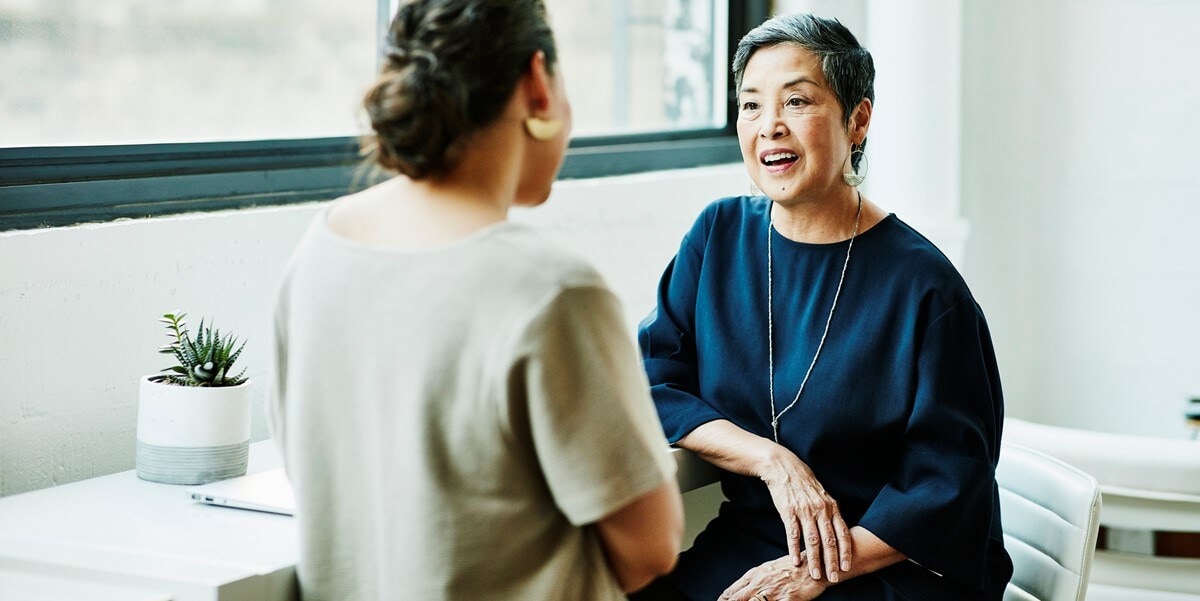 two women sitting in an office meeting